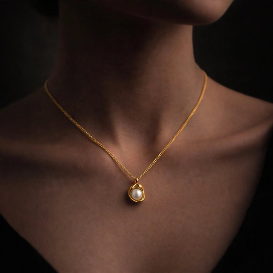Valora pearl pendant necklace worn on a model — dark background