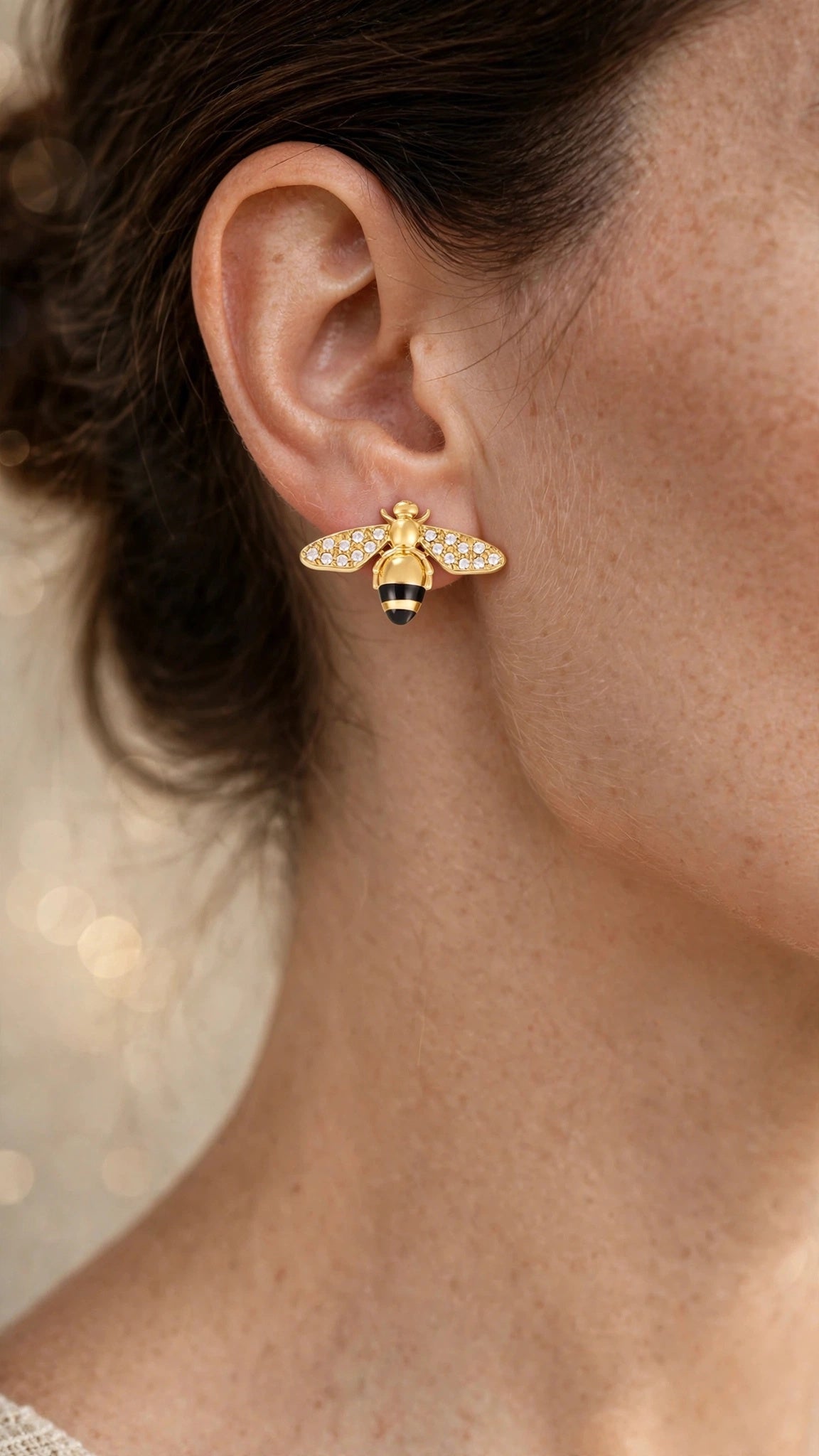 Abeja Dorada bee earrings worn close-up