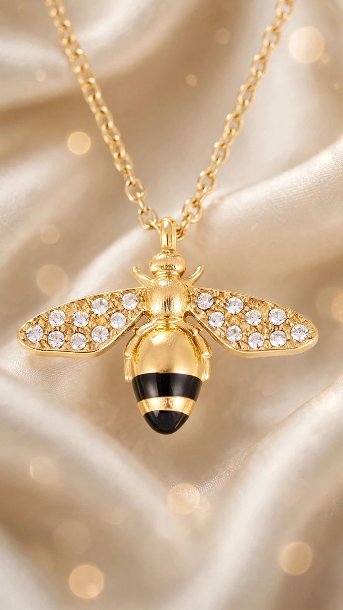 Close-up of the Abeja Dorada bee pendant with cubic zirconia inlay