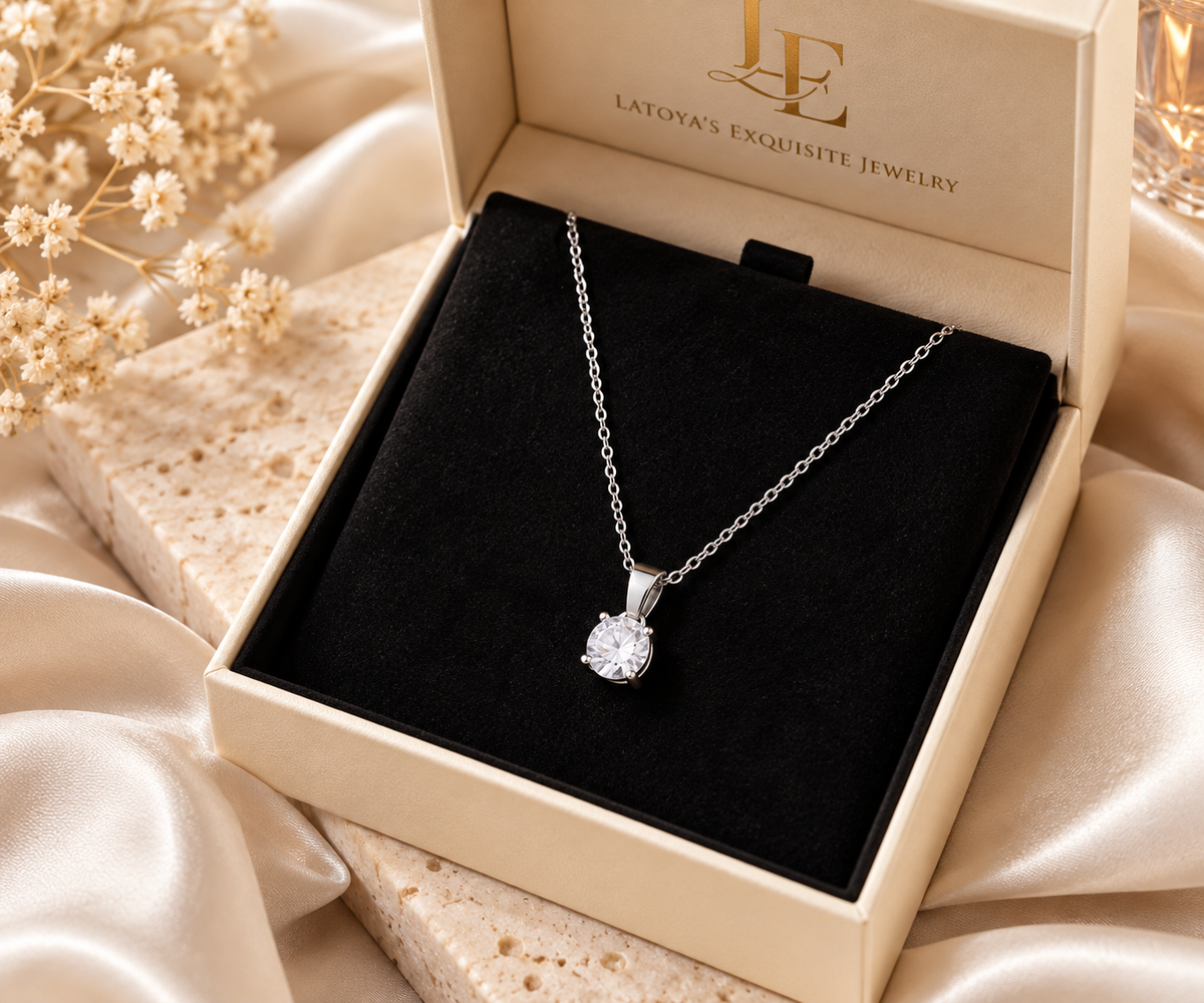 Silver-tone necklace displayed in its jewelry box
