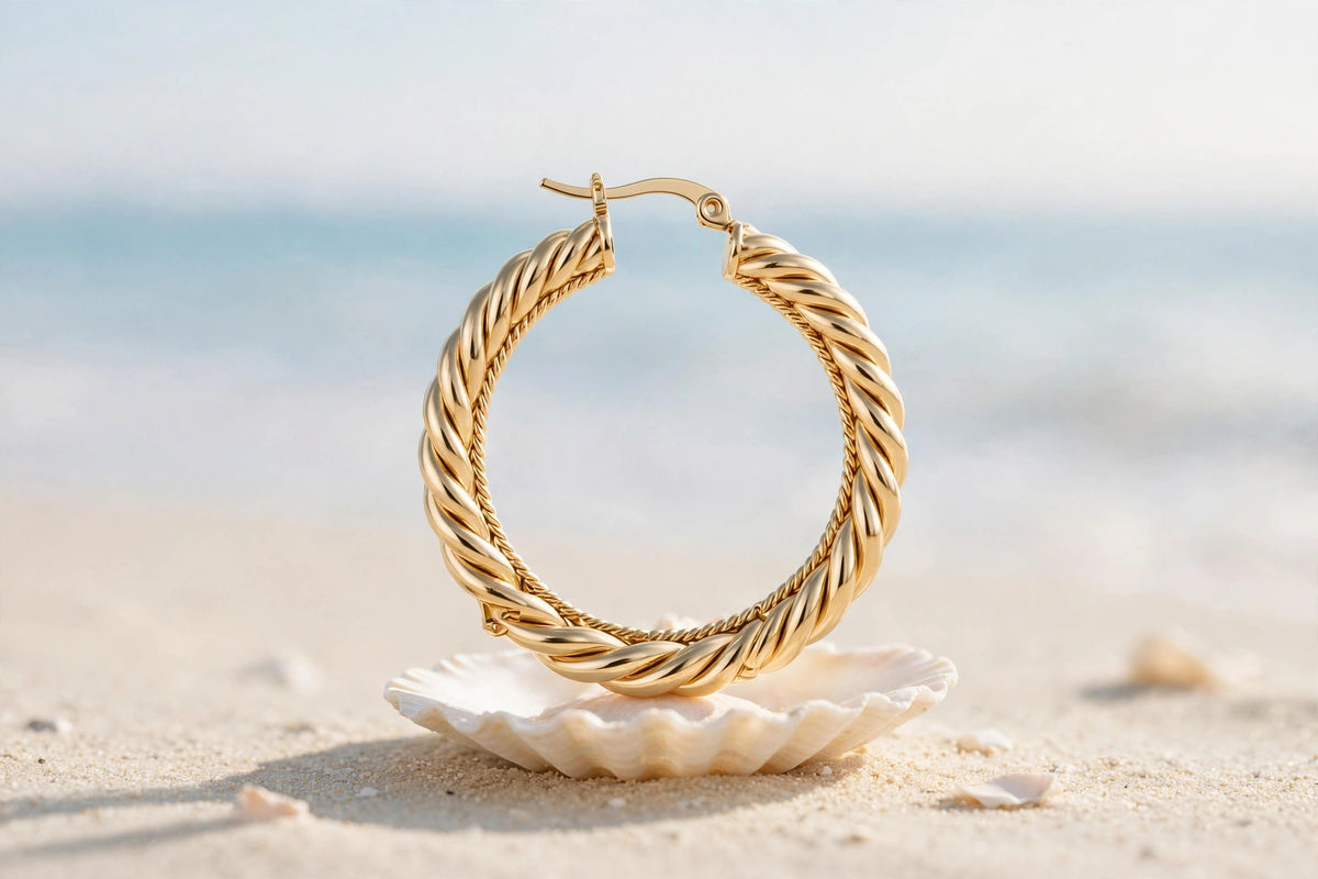 Rosali gold hoop styled on seashell at the beach