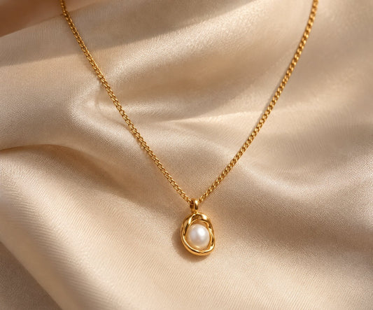 Valora freshwater pearl pendant necklace resting on champagne silk